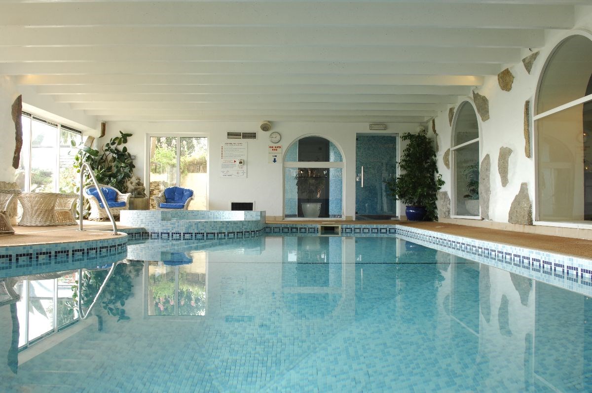 A warm indoor swimming pool with sauna and steam room