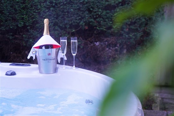 Relax in your own private hot tub with a glass of Champagne 
