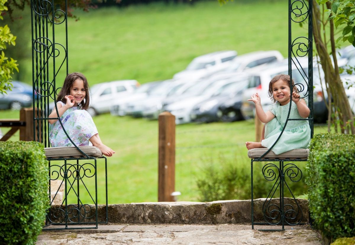 Two happy little wedding guests enjoying the garden