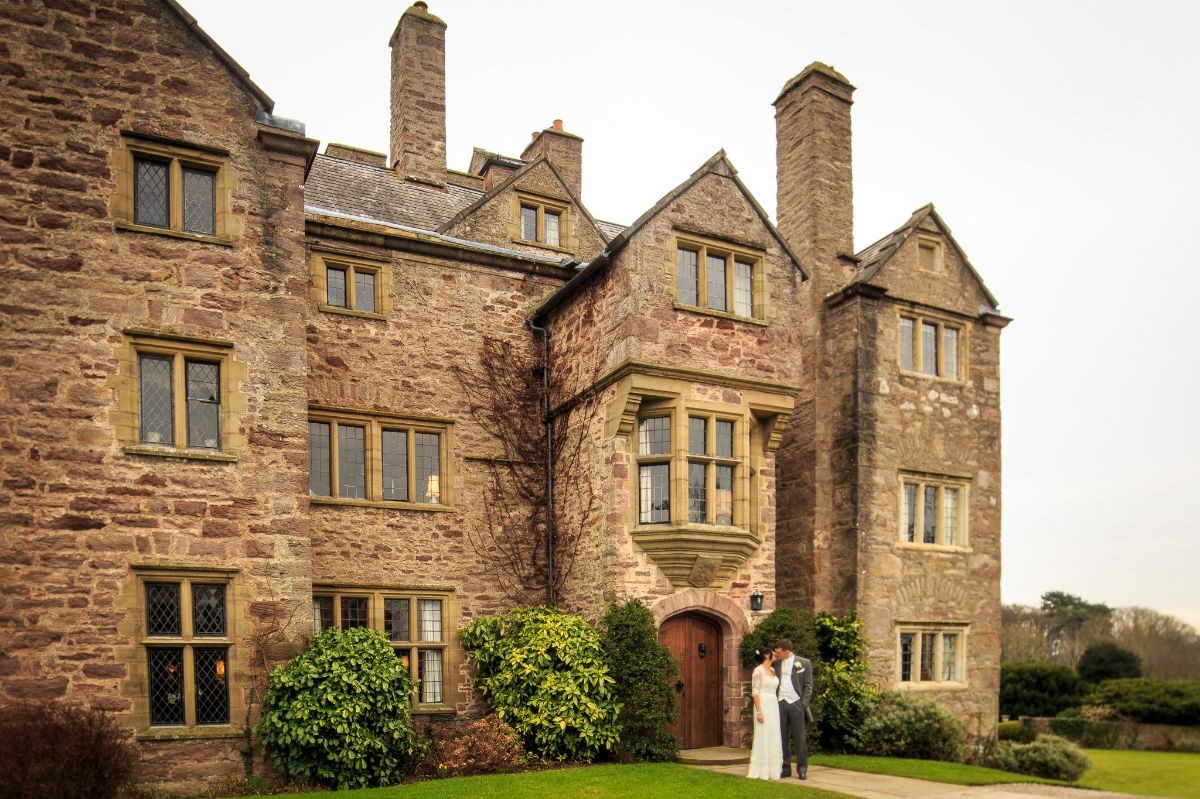 Bridal couple at entrance to Bodysgallen Hall 