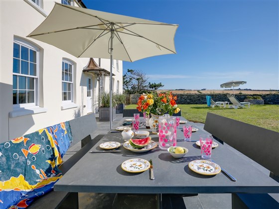 Front terrace with slate table, bbq & range of garden furniture.
