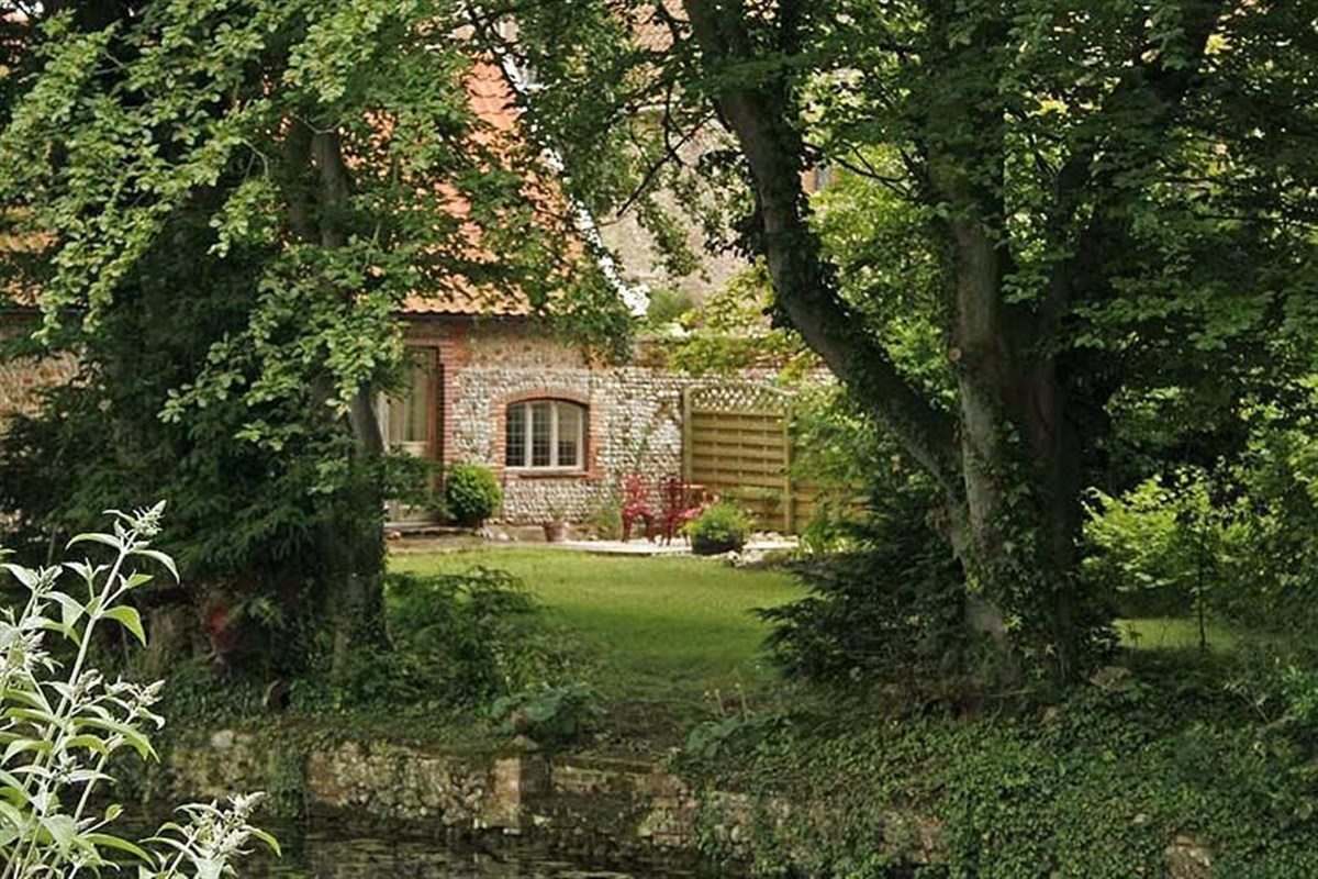 View to the back Of Moat House from across the moatThe