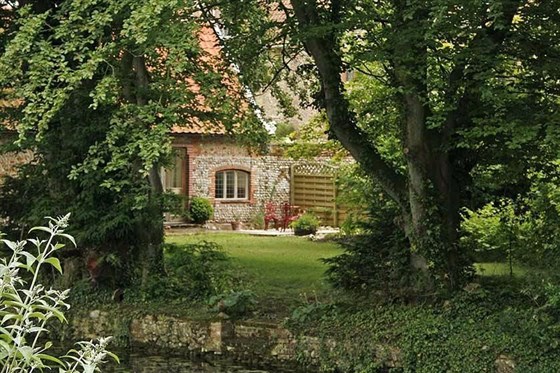 View to the back Of Moat House from across the moatThe