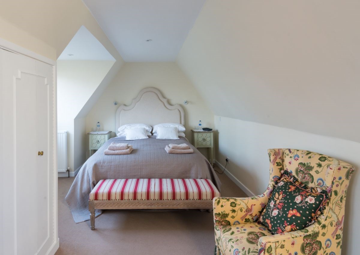 Crisp white cotton sheets and mattress topper add to the luxury