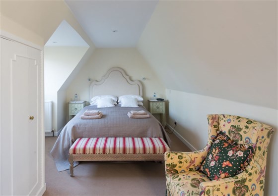 Crisp white cotton sheets and mattress topper add to the luxury