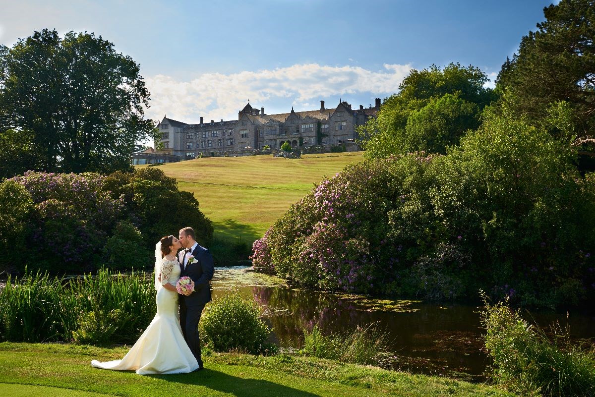 In the grounds with hotel in the back