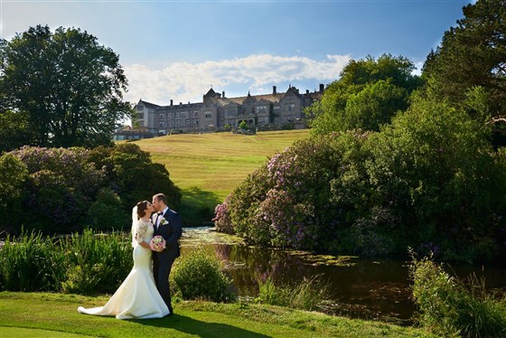 In the grounds with hotel in the back