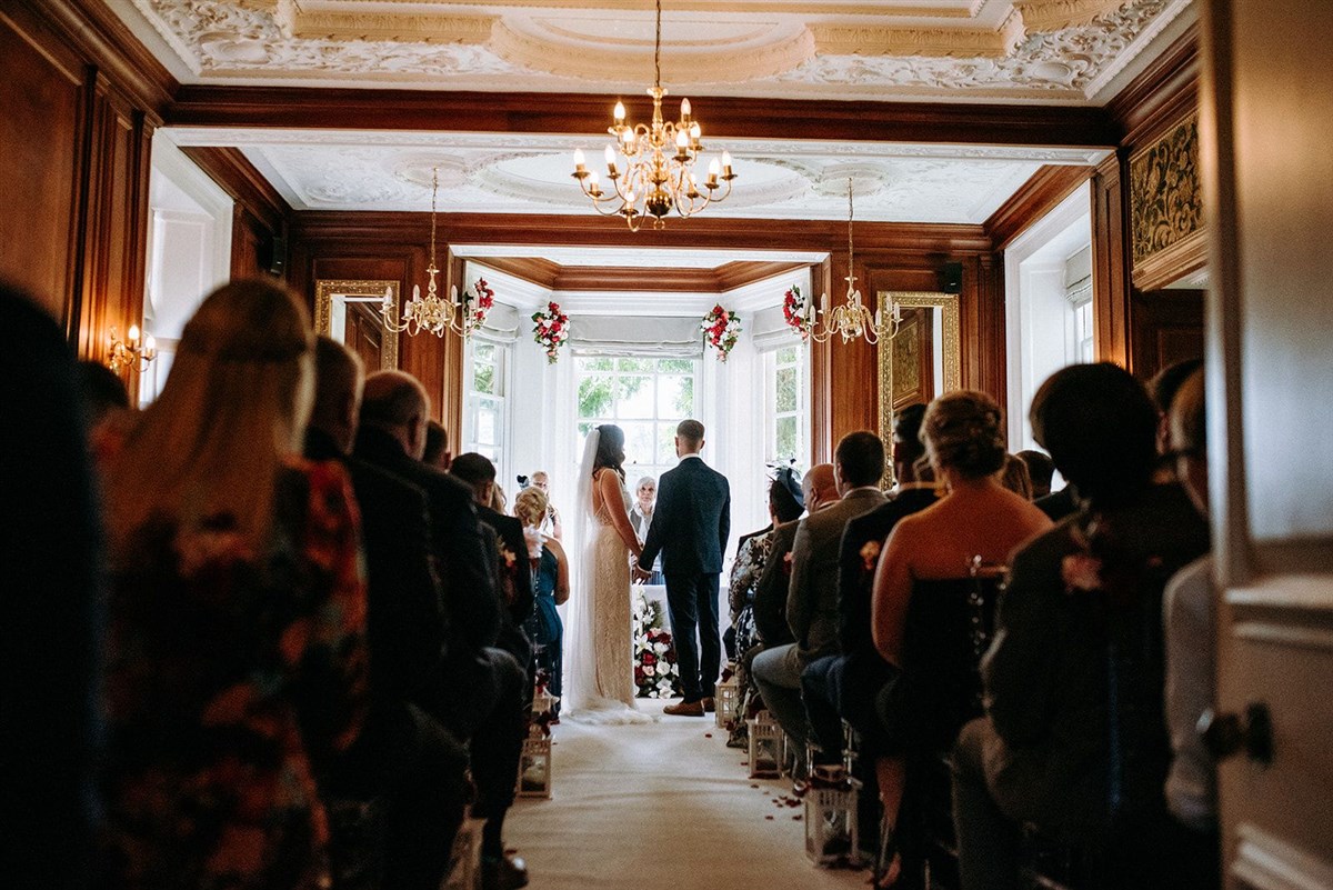 Couple exchanging vows in the Oak Hall