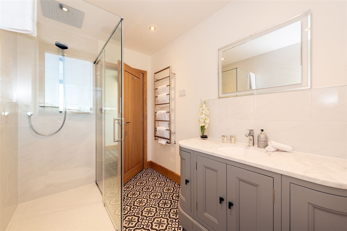 The en suite for Bedroom 2 has a big walk in shower