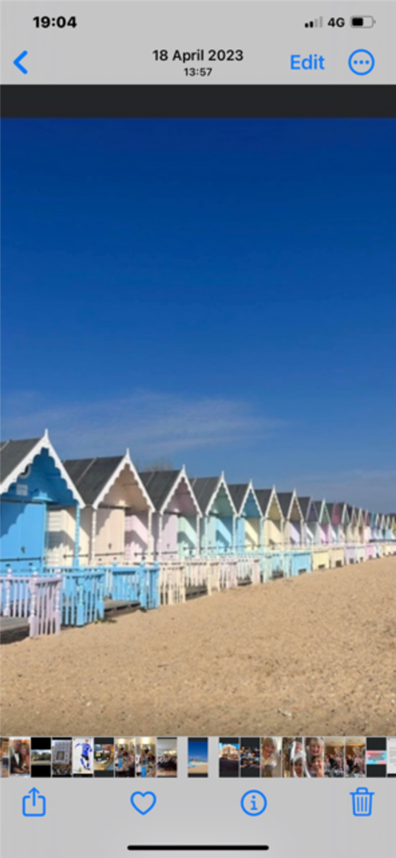 Colorful Beach Huts on Sandy Shore