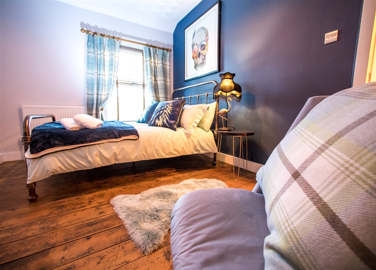 Main Bedroom viewed from Dressing table showing double sized iron bed