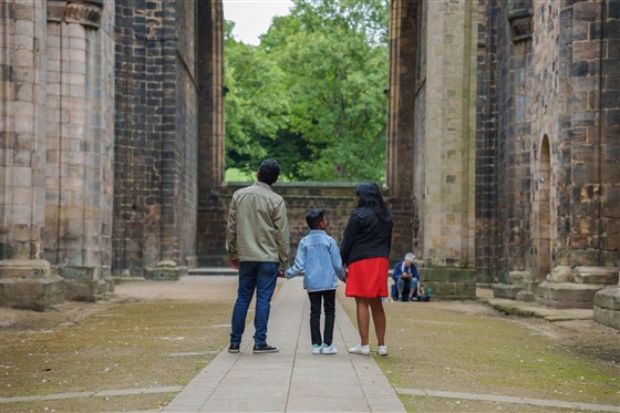 Photograph of family in an opening in Kirkstall Abbey