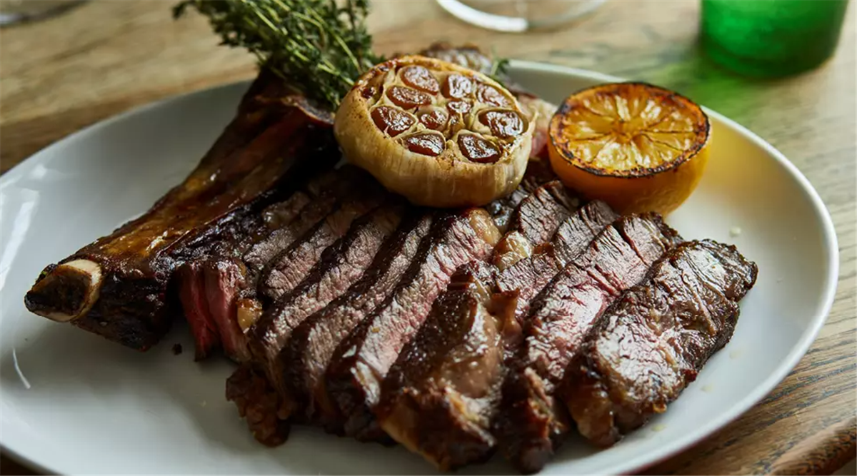 Salt aged Glenarm Estate rib of beef for two, confit garlic and burnt lemon.