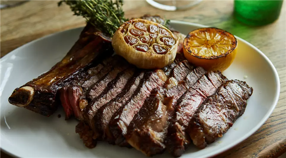 Salt aged Glenarm Estate rib of beef for two, confit garlic and burnt lemon.