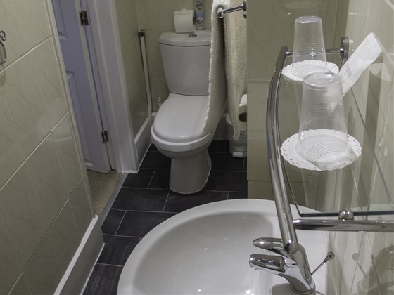 Bathroom in room with king size bed