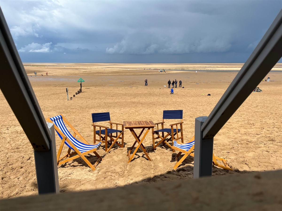 Beach view with deck and director chairs and officer chair