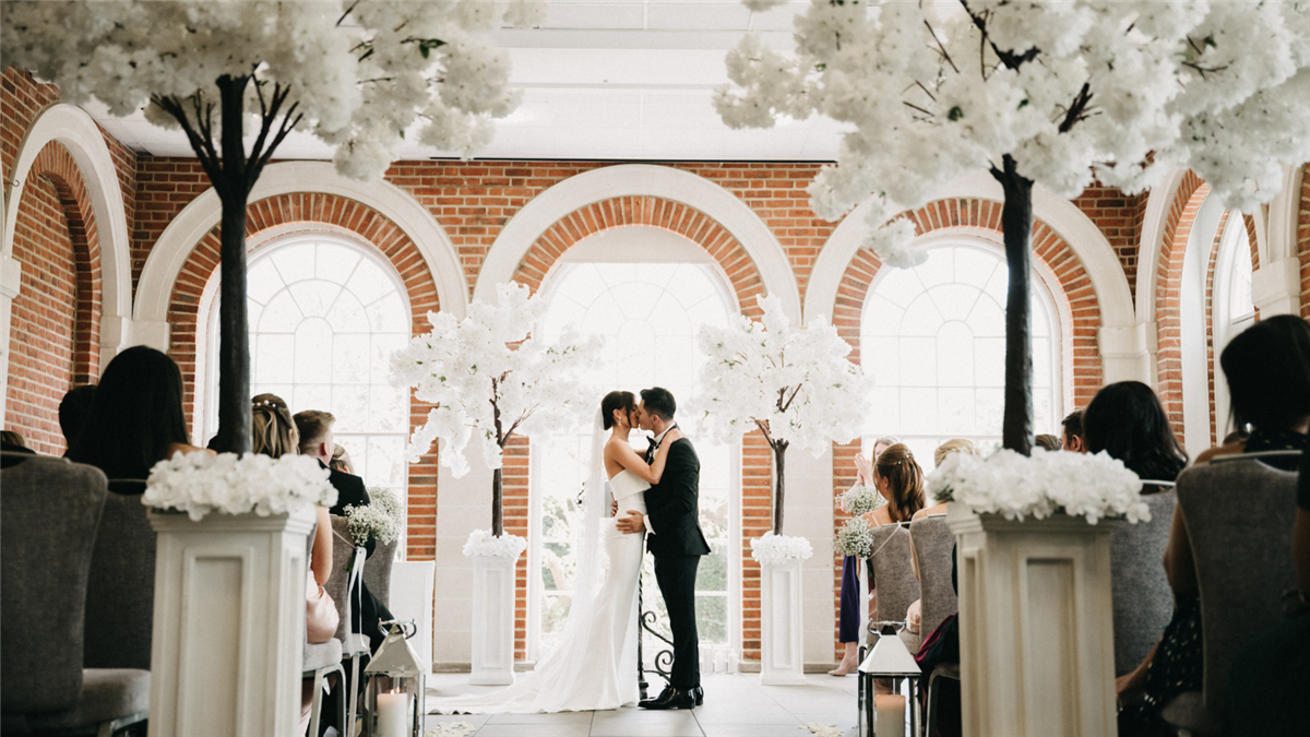 Bride & Groom exchanging vows in The Orangery