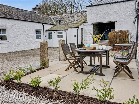 The sheltered courtyard patio at Abbotway Cottage