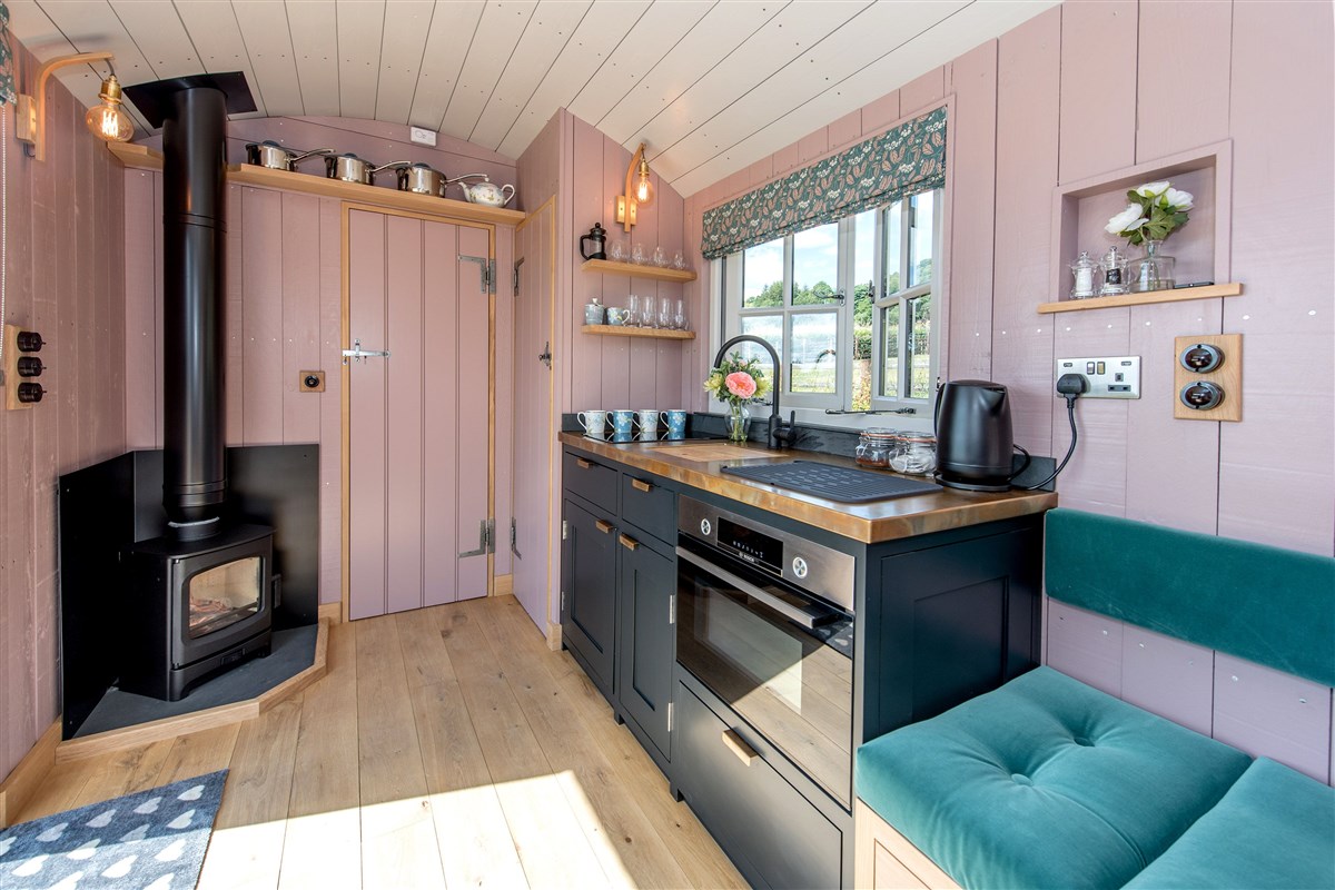 A Shaker style kitchen with an oven, hob & fridge