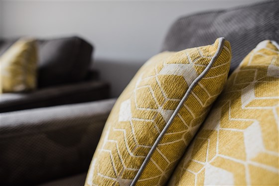 Comfy settee in the lounge with a TV