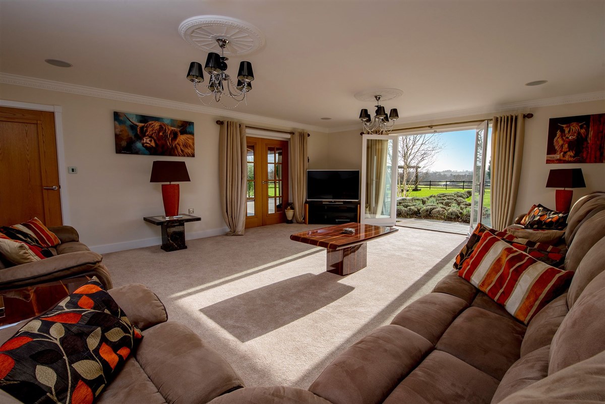 A sumptuous and spacious living room, with doors onto the garden
