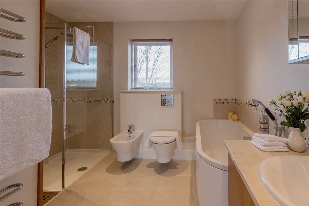 The main bathroom has a walk in shower and a big bath tub