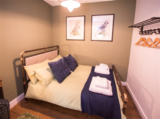 2nd Bedroom - tasteful linens, flurry towels and clothes handing rail