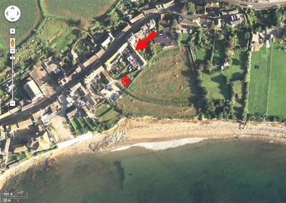 Aerial shot shows cottage and parking