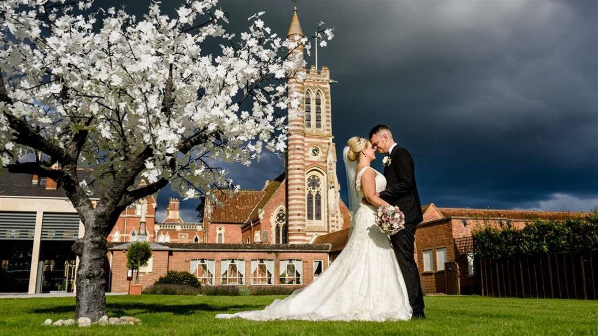 Newlyweds in front of Stanbrook Abbey