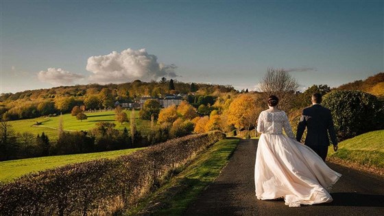Newlyweds in the grounds in Autumn